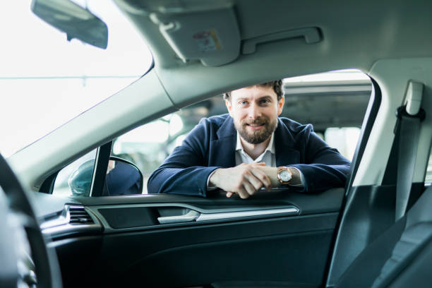 istock First test drive. Handsome young man ready to make first test drive 1212700047
