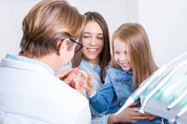 istock Young mother with daughter at dentist office 1212700366