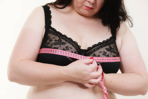 istock Woman measuring her chest breasts bust size 1212700570