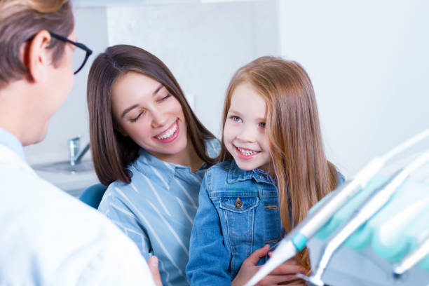 istock Young mother with daughter at dentist office 1212701226