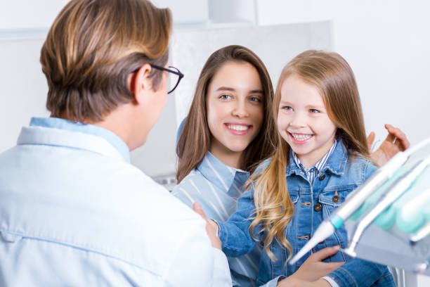 istock Young mother with daughter at dentist office 1212701307