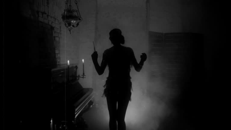 Old film style grain added. black and white color dark mysterious female silhouette. mouthpiece in hand. short sexy vintage dress 20s. retro young beautiful woman dances. backdrop room, piano, smoke