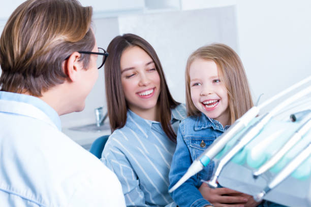 istock Young mother with daughter at dentist office 1212701622