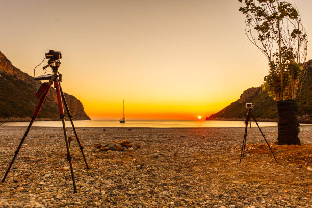 istock Camera taking picture of sunrise over sea surface 1212702782