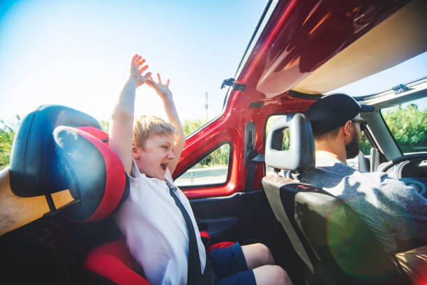 istock Father Driving Open Top Car with his son 1212703446