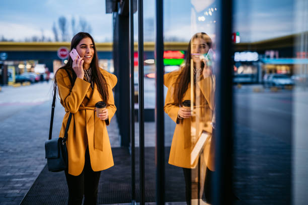istock Woman talking on phone and window shopping 1212704511