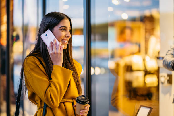 istock Woman talking on phone and window shopping 1212704553
