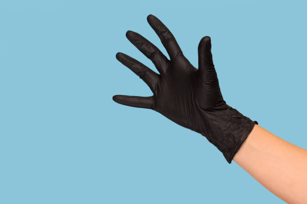 istock A hand in a black glove shows front five on a blue background. Hygiene, tattoo 1212707407