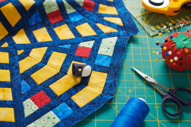 istock Fragment of a quilt, surrounded by tools for quilting 1212707957