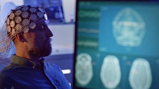 In modern Neurological Research Laboratory. EEG animation on monitor screen.