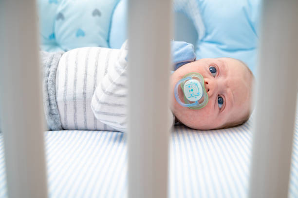 istock Beautiful baby boy sucking pacifier 1212708085