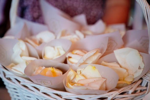 rose petals in the envelopes for the guests in a white basket. showered the newlyweds. wedding. close up