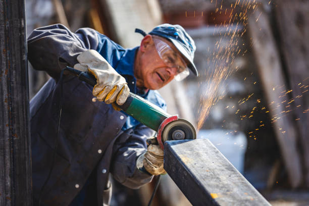 Old Working Class Man Grinding Steel stock photo