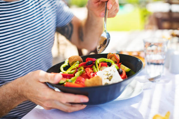 istock Men eating Greek Salad 1212709118