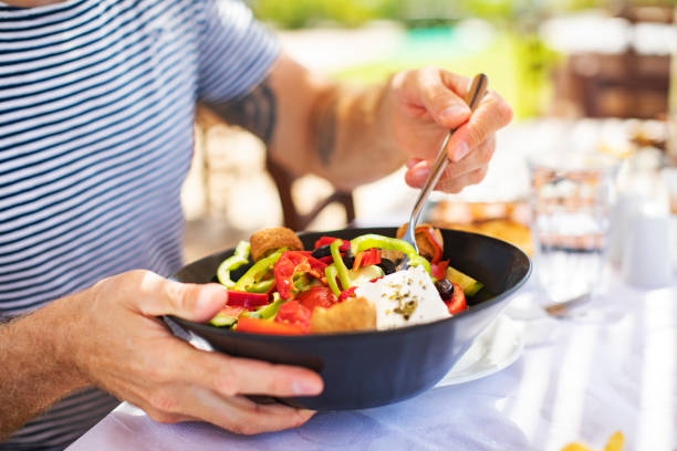 istock Men eating Greek Salad 1212709123