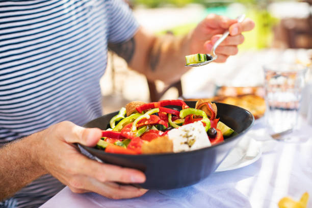istock Men eating Greek Salad 1212709126