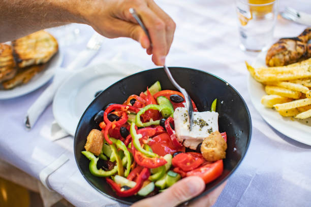 istock Men eating Greek Salad 1212709137