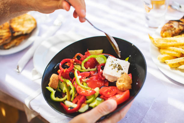 istock Men eating Greek Salad 1212709138