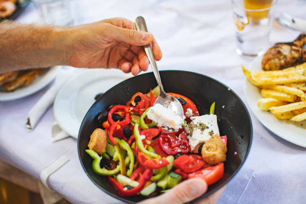 istock Men eating Greek Salad 1212709142