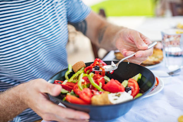 istock Men eating Greek Salad 1212709143