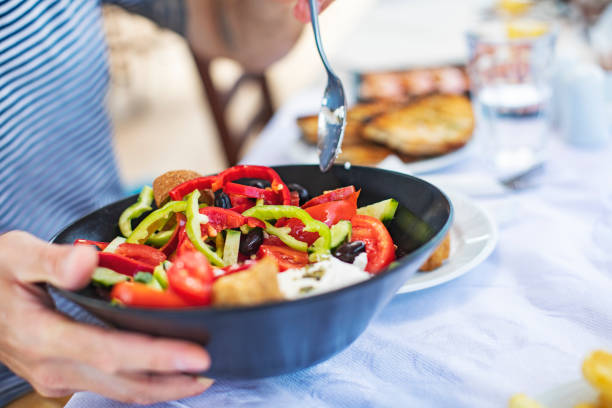 istock Men eating Greek Salad 1212709159