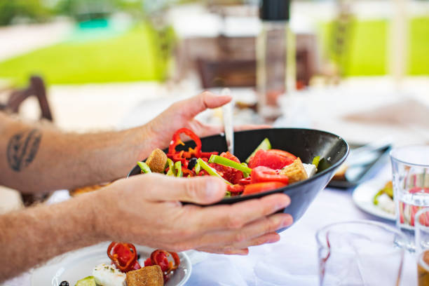 istock Men eating Greek Salad 1212709171