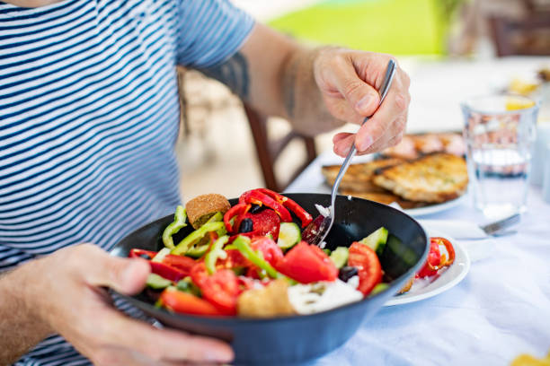 istock Men eating Greek Salad 1212709173