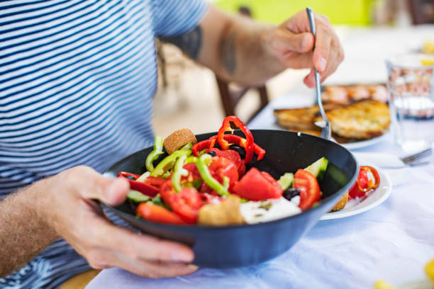 istock Men eating Greek Salad 1212709175