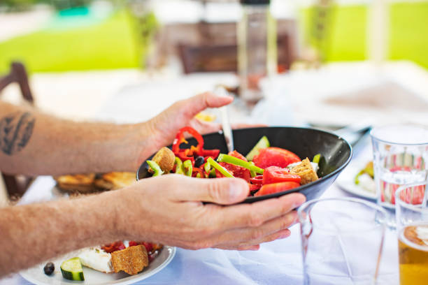 istock Men eating Greek Salad 1212709205