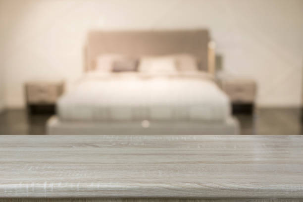 istock Empty wooden board and blurred modern bedroom with house interior as background. Abstract pattern. 1212710425
