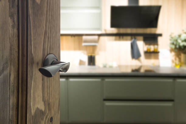 istock Opened wooden door and view to modern kitchen . 1212711617