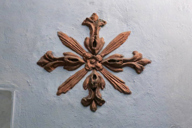 istock bronze colored decoration of a flower pattern on a light blue wall 1212712109