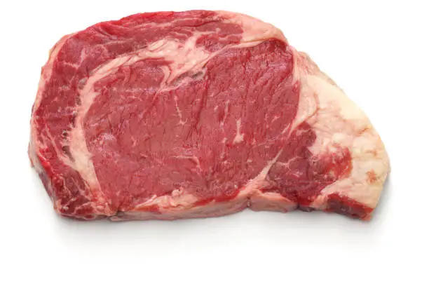 raw rib eye steak isolated on white background