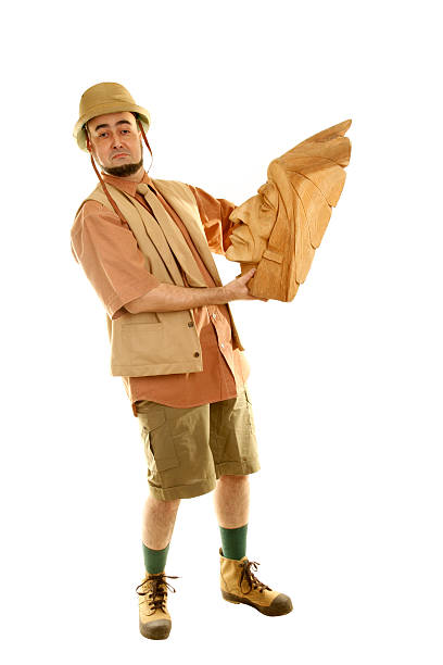 istock Adventurer explorer is holding wooden Indian idol 121272016
