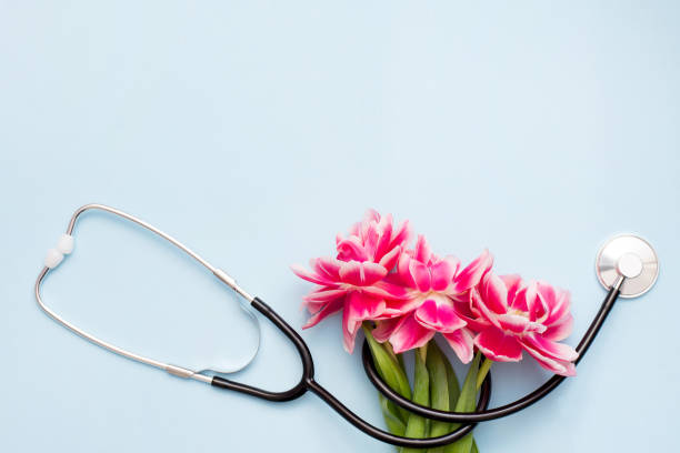 istock A Stethoscope on blue background with a spring flowers. 1212721447