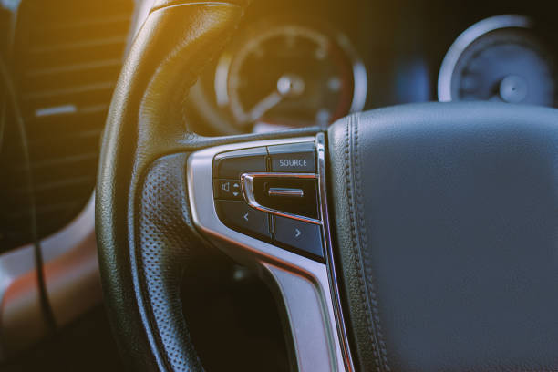 istock Button volume car control for turning on new car radio system,Button on steering wheel on car 1212721533