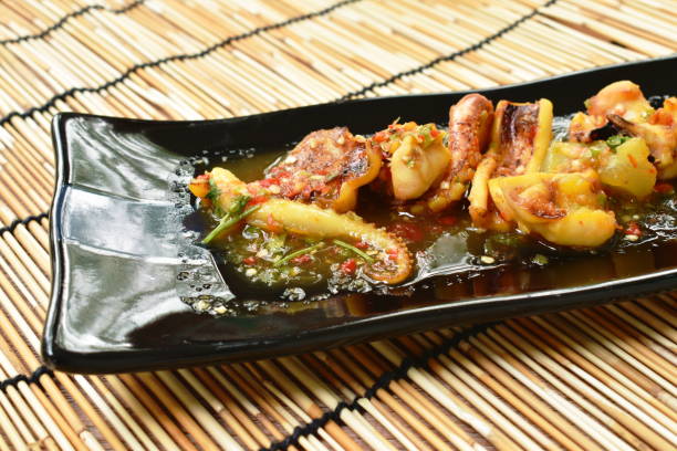 istock grilled squid dressing spicy sauce 1212721753