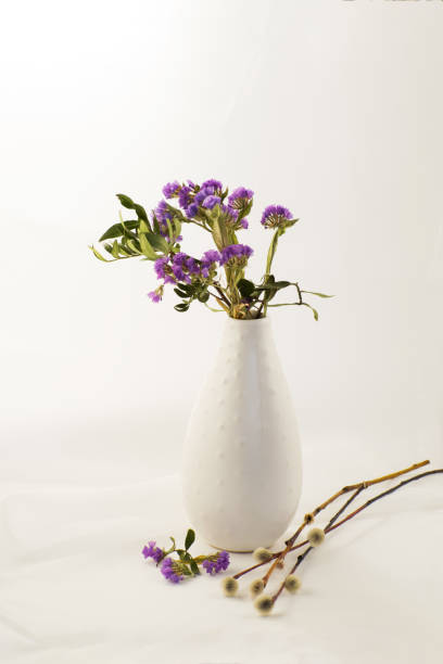 istock Spring lilac flowers with willow branches in a vase. 1212723081
