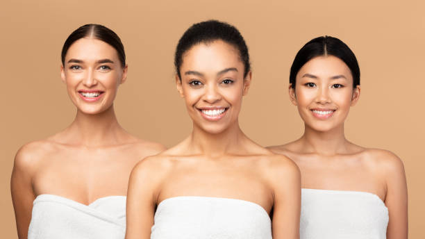 istock Three Happy Women In Bath Towels Posing, Beige Background, Panorama 1212727150