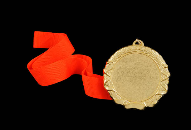 istock Gold medal with red ribbon isolated 1212727639
