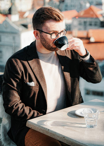 istock One caucasian man drinks coffee from cup on cafe 1212728406