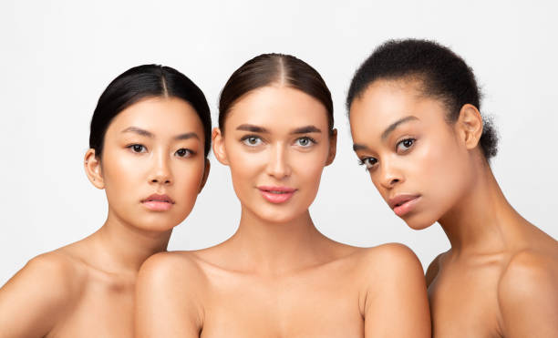 istock Three Multiracial Models Girls Posing Naked In Studio 1212728516