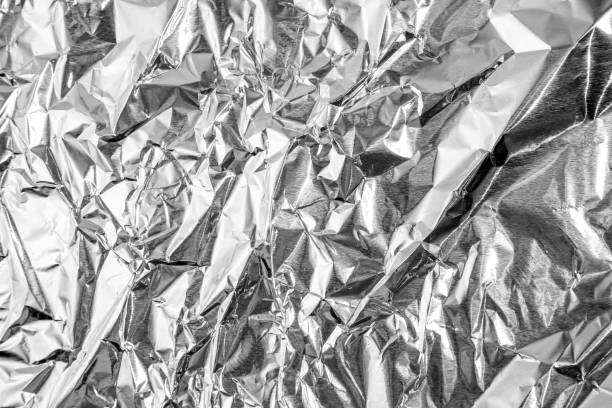istock aluminium foil crumpled Silver texture abstract background 1212729215