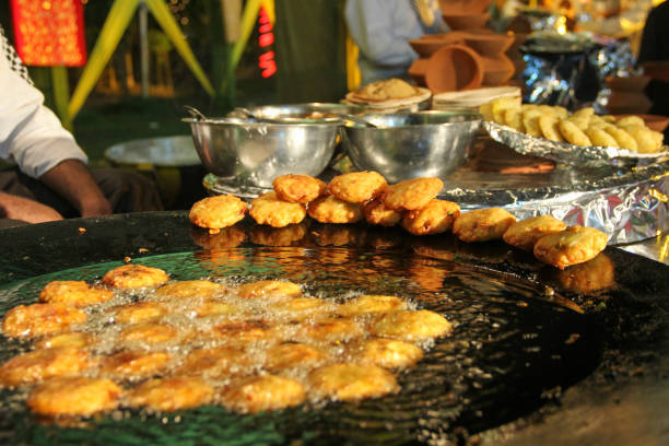 Street Food Indian style Fried potatoes Aloo Tikki Boiling potatoes in hot oil on street side food stall india street food fast food singh stock pictures, royalty-free photos & images