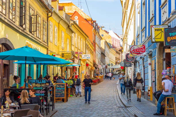Street cafe in Zagreb Old Town,Croatia. This pic shows street cafe and local peole enjoying their coffee together in Zagreb,Croatia.Zagreb is known for its coffee culture. The pic is taken in day time and in october 2019. experiential travel stock pictures, royalty-free photos & images