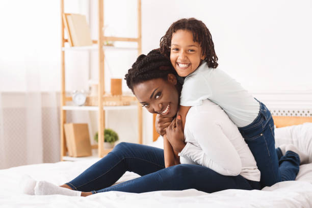 istock Black girl hudding her mom at home 1212739026