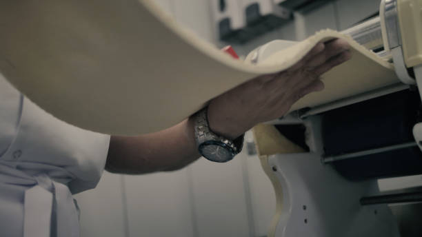 istock chef pulls dough out of the mechanism 1212740034