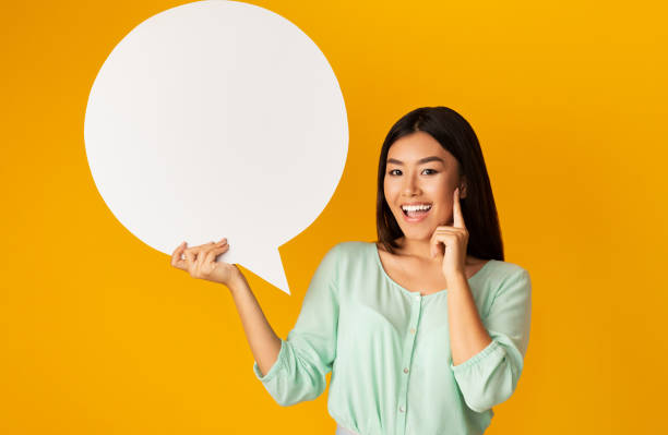 istock Girl Having Idea Holding Speech Bubble On Yellow Background, Mockup 1212740370