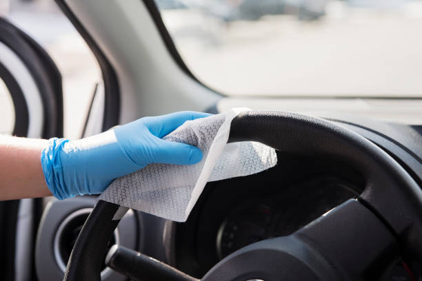 istock Hand with glove wiping car steering wheel. 1212740748