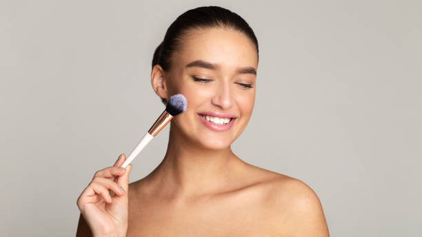 istock Beautiful caucasian young woman using her brush 1212741321